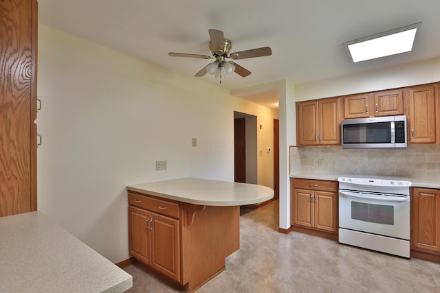 6070 Barberry Holw, Columbus, OH 43213 - kitchen with stainless steel microwave, electric range, a peninsula, tasteful backsplash, and brown cabinets