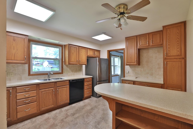 6070 Barberry Holw, Columbus, OH 43213 - kitchen with dishwasher, freestanding refrigerator, a sink, brown cabinets, and light countertops