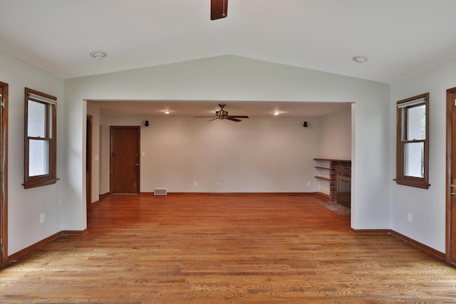 6070 Barberry Holw, Columbus, OH 43213 - unfurnished living room featuring a ceiling fan, lofted ceiling, plenty of natural light, light wood finished floors, and baseboards