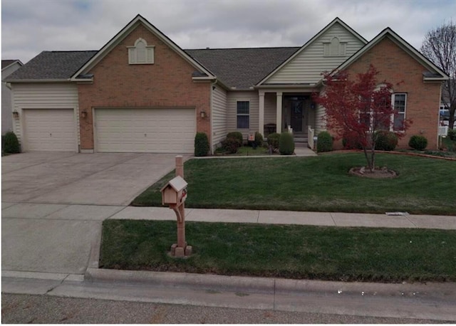 traditional-style house featuring a front lawn, concrete driveway, brick siding, and a garage