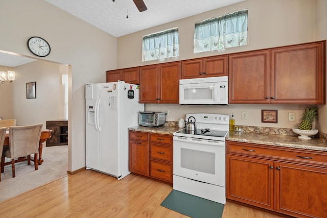 890 Brockwell Dr, Westerville, OH 43081 - kitchen with white appliances, brown cabinets, light wood-type flooring, and a high ceiling