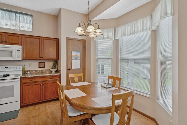 890 Brockwell Dr, Westerville, OH 43081 - kitchen featuring white appliances, light wood-type flooring, a chandelier, and brown cabinets