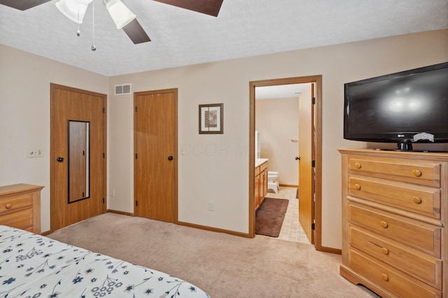 890 Brockwell Dr, Westerville, OH 43081 - bedroom with light colored carpet, ensuite bathroom, baseboards, and a textured ceiling