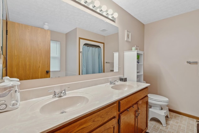 890 Brockwell Dr, Westerville, OH 43081 - full bathroom featuring toilet, double vanity, a textured ceiling, baseboards, and a shower with curtain