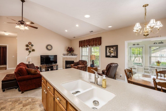 4 Claire Ct, Circleville, OH 43113 - kitchen with open floor plan, a sink, lofted ceiling, light countertops, and decorative light fixtures