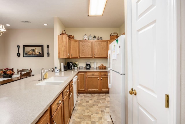 4 Claire Ct, Circleville, OH 43113 - kitchen with a sink, white appliances, light countertops, recessed lighting, and brown cabinetry