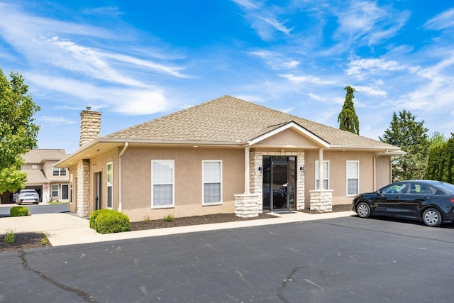 4 Claire Ct, Circleville, OH 43113 - view of front facade featuring a chimney, stucco siding, and a shingled roof