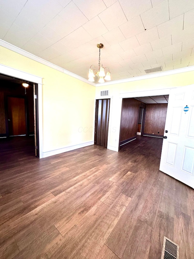 619 Sugar St, Marion, OH 43302 - unfurnished room with a chandelier, dark wood-style floors, crown molding, and baseboards