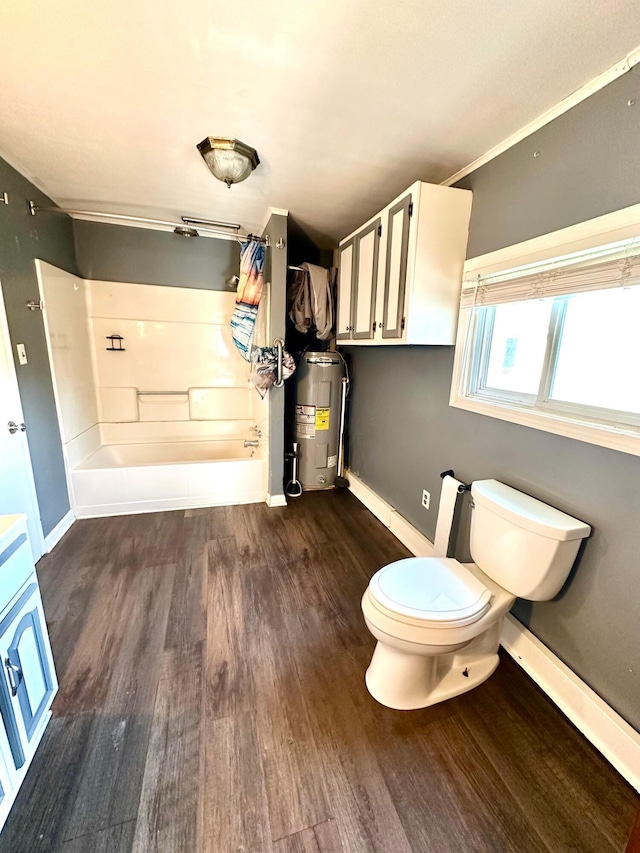 619 Sugar St, Marion, OH 43302 - bathroom with water heater, wood finished floors, tub / shower combination, toilet, and baseboards