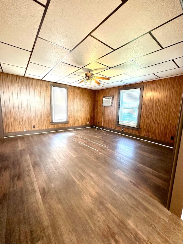 619 Sugar St, Marion, OH 43302 - spare room with a drop ceiling, wood finished floors, a wall unit AC, wood walls, and ceiling fan