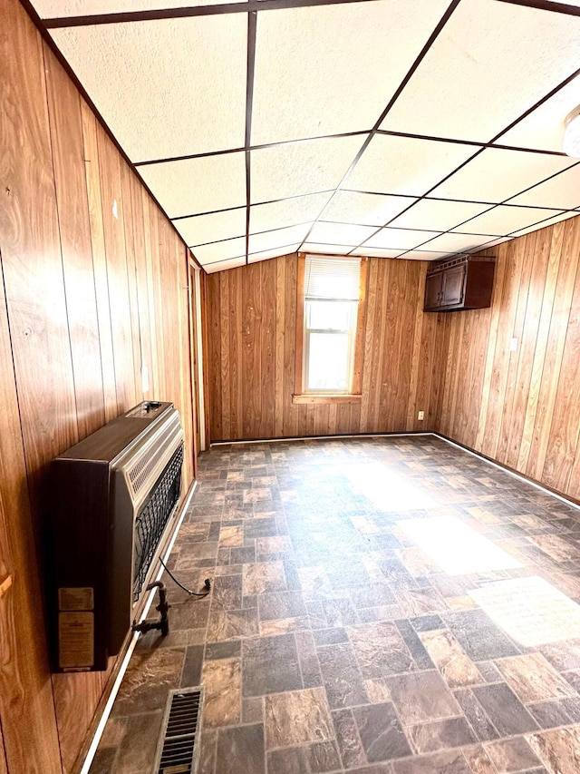 619 Sugar St, Marion, OH 43302 - unfurnished living room with wooden walls, heating unit, and a drop ceiling