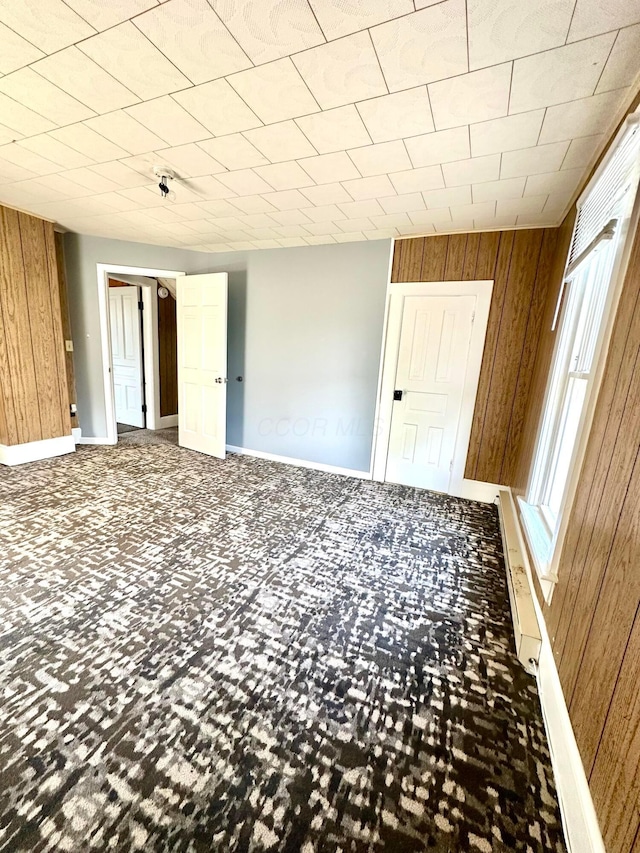 619 Sugar St, Marion, OH 43302 - unfurnished room featuring wooden walls, baseboards, and carpet