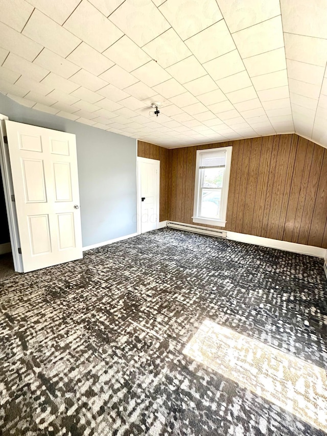 619 Sugar St, Marion, OH 43302 - carpeted spare room featuring wooden walls, baseboards, and lofted ceiling