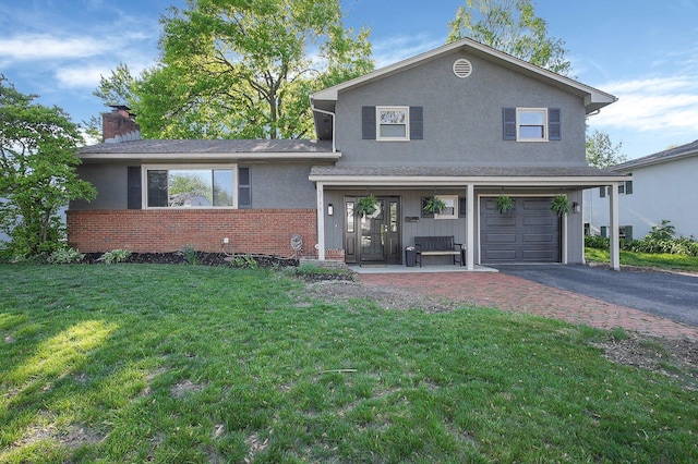 2711 Montcalm Rd, Columbus, OH 43221 - tri-level home with brick siding, a front yard, driveway, an attached garage, and a chimney