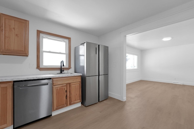 524 Avondale Ave, Marion, OH 43302 - kitchen with appliances with stainless steel finishes, a sink, light countertops, and light wood-style flooring