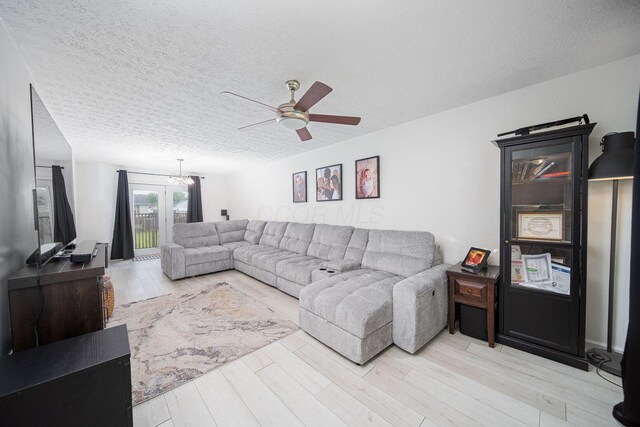 5039 Lee Rd, South Bloomfield, OH 43103 - living area with ceiling fan, wood finished floors, a textured ceiling, and a chandelier