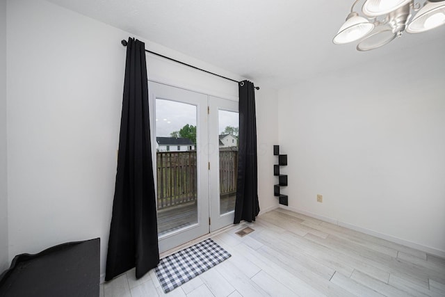 5039 Lee Rd, South Bloomfield, OH 43103 - doorway with a chandelier, light wood-type flooring, and baseboards