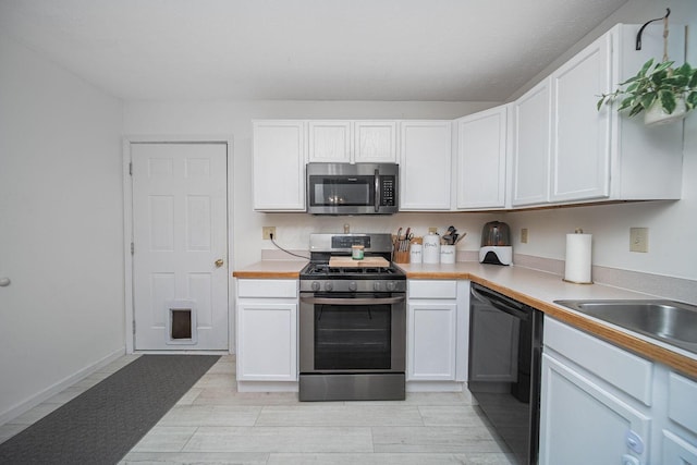 5039 Lee Rd, South Bloomfield, OH 43103 - kitchen with stainless steel appliances, white cabinetry, and light countertops