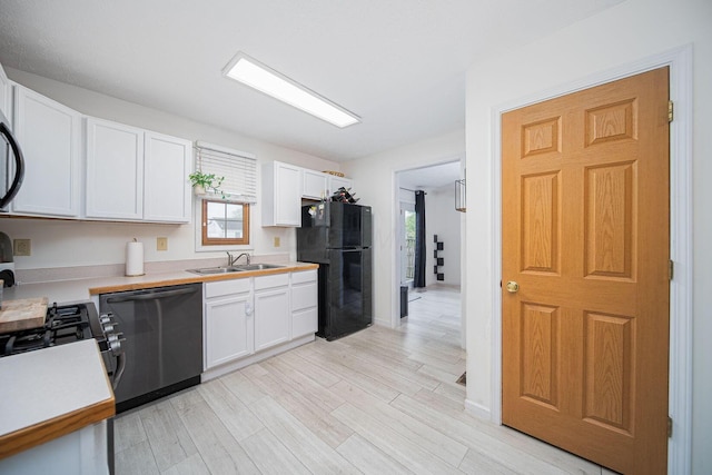 5039 Lee Rd, South Bloomfield, OH 43103 - kitchen with dishwashing machine, freestanding refrigerator, a sink, and light countertops
