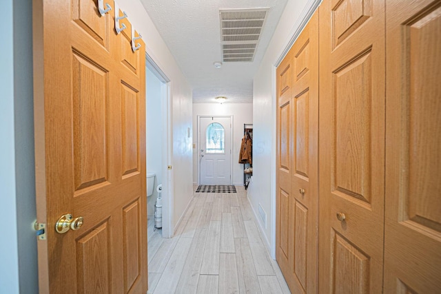 5039 Lee Rd, South Bloomfield, OH 43103 - hall featuring light wood-type flooring, baseboards, and a textured ceiling