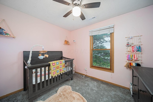 5039 Lee Rd, South Bloomfield, OH 43103 - carpeted bedroom with baseboards, a crib, a ceiling fan, and a textured ceiling