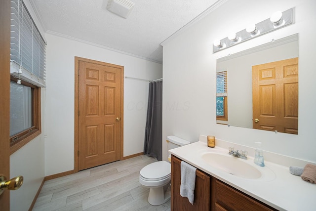 5039 Lee Rd, South Bloomfield, OH 43103 - bathroom featuring toilet, ornamental molding, wood finished floors, vanity, and a textured ceiling