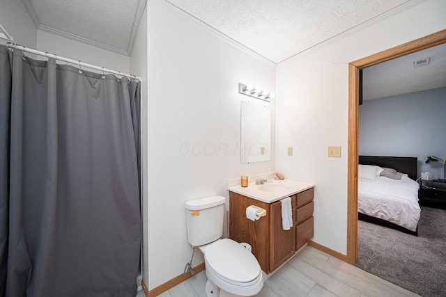 5039 Lee Rd, South Bloomfield, OH 43103 - ensuite bathroom with ornamental molding, vanity, a textured ceiling, toilet, and wood finished floors