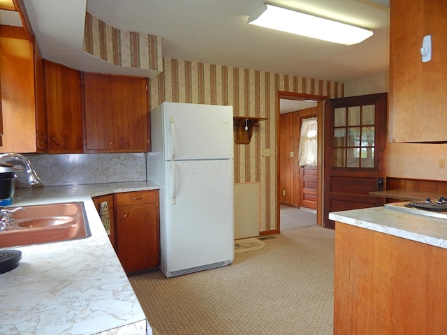 2705 County Road 118, Rushsylvania, OH 43347 - kitchen featuring freestanding refrigerator, wallpapered walls, a sink, brown cabinets, and light countertops