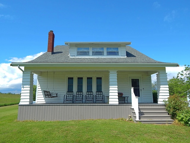 2705 County Road 118, Rushsylvania, OH 43347 - bungalow with a porch, a chimney, a front lawn, and roof with shingles