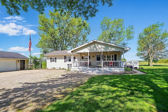 12955 State Route 188, Thornville, OH 43076 - view of front of home with covered porch, a front lawn, and gravel driveway