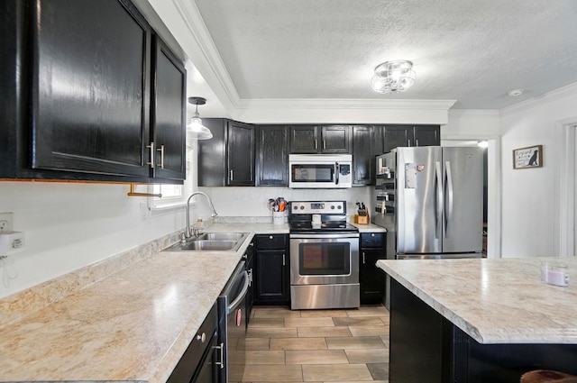 12955 State Route 188, Thornville, OH 43076 - kitchen featuring stainless steel appliances, a sink, dark cabinetry, light countertops, and ornamental molding
