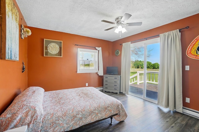 12955 State Route 188, Thornville, OH 43076 - bedroom with access to outside, a textured ceiling, wood finished floors, a baseboard radiator, and a ceiling fan