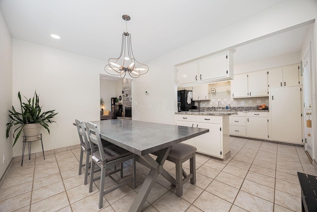 dining room with a chandelier, light tile patterned floors, and recessed lighting