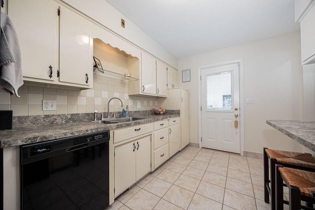 kitchen featuring black dishwasher, a sink, backsplash, dark countertops, and light tile patterned flooring