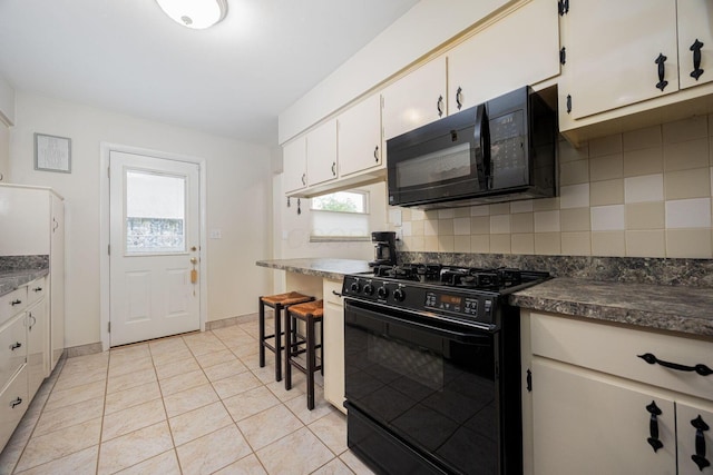 kitchen featuring black appliances, dark countertops, backsplash, and light tile patterned floors