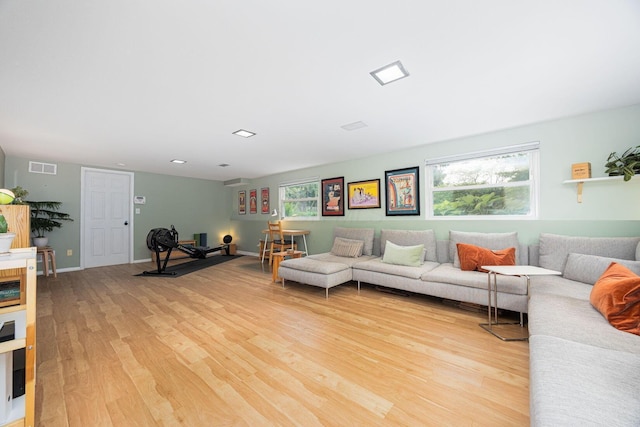 living area with light wood-style flooring and baseboards