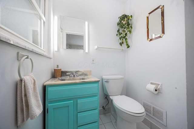 bathroom with toilet, tile patterned floors, and vanity