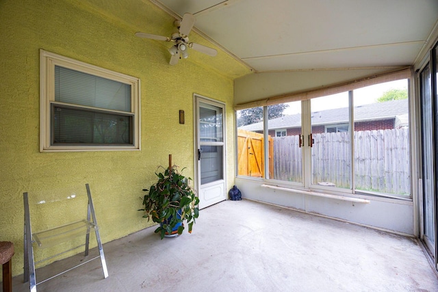 unfurnished sunroom featuring vaulted ceiling and ceiling fan
