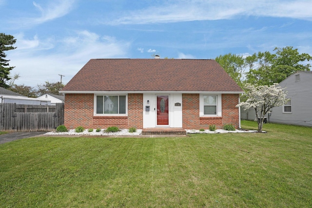 view of front of property with brick siding and roof with shingles