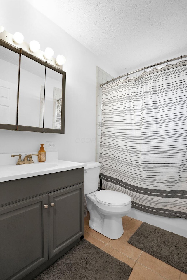 bathroom with toilet, vanity, tile patterned flooring, a textured ceiling, and a shower with shower curtain