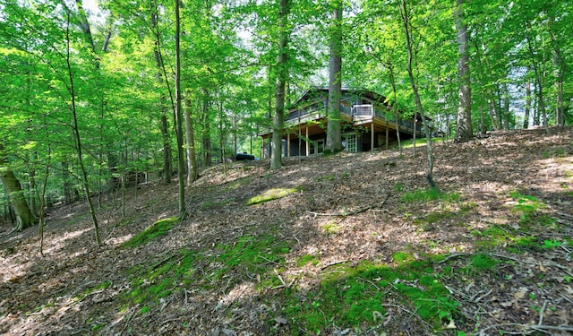 1160 Flathead Ln, Sugar Grove, OH 43155 - view of yard featuring a wooden deck and a forest view