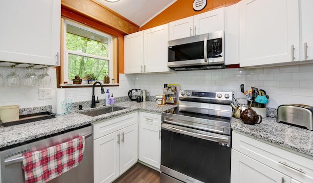 1160 Flathead Ln, Sugar Grove, OH 43155 - kitchen featuring appliances with stainless steel finishes, vaulted ceiling, white cabinetry, and tasteful backsplash