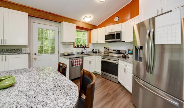 1160 Flathead Ln, Sugar Grove, OH 43155 - kitchen with appliances with stainless steel finishes, lofted ceiling, wood finished floors, white cabinets, and light stone countertops