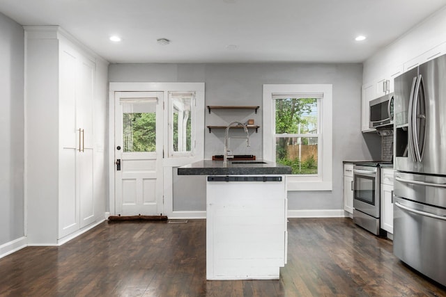 1369 Meadow Rd, Columbus, OH 43212 - kitchen featuring appliances with stainless steel finishes, a sink, dark countertops, white cabinetry, and recessed lighting