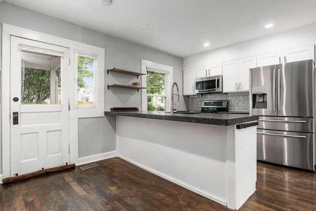 1369 Meadow Rd, Columbus, OH 43212 - kitchen featuring appliances with stainless steel finishes, a sink, white cabinetry, a peninsula, and recessed lighting