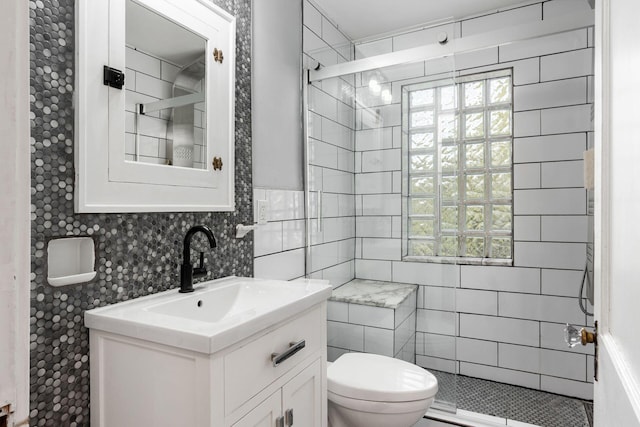 1369 Meadow Rd, Columbus, OH 43212 - full bathroom with a shower stall, tile walls, toilet, and vanity