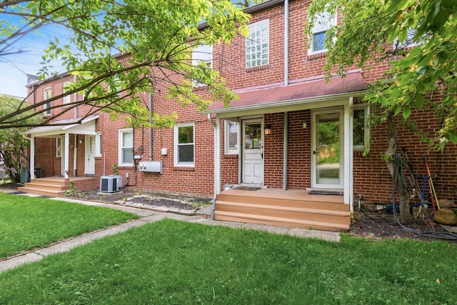 1369 Meadow Rd, Columbus, OH 43212 - rear view of house with cooling unit, a lawn, and brick siding