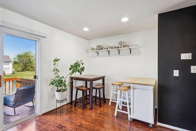 dining room with wood finished floors, recessed lighting, and baseboards
