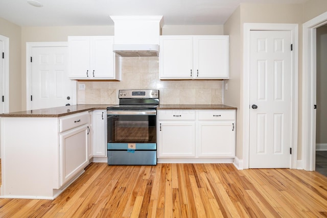 7885 Upper Twin Rd, South Salem, OH 45681 - kitchen featuring stainless steel range with electric stovetop, a peninsula, light wood-type flooring, white cabinetry, and tasteful backsplash