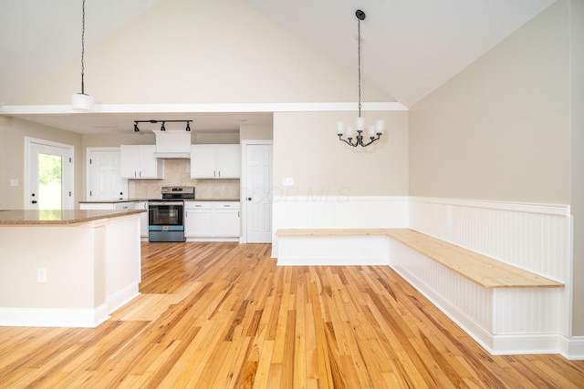 7885 Upper Twin Rd, South Salem, OH 45681 - kitchen featuring stainless steel electric range oven, light wood-style floors, white cabinetry, vaulted ceiling, and pendant lighting